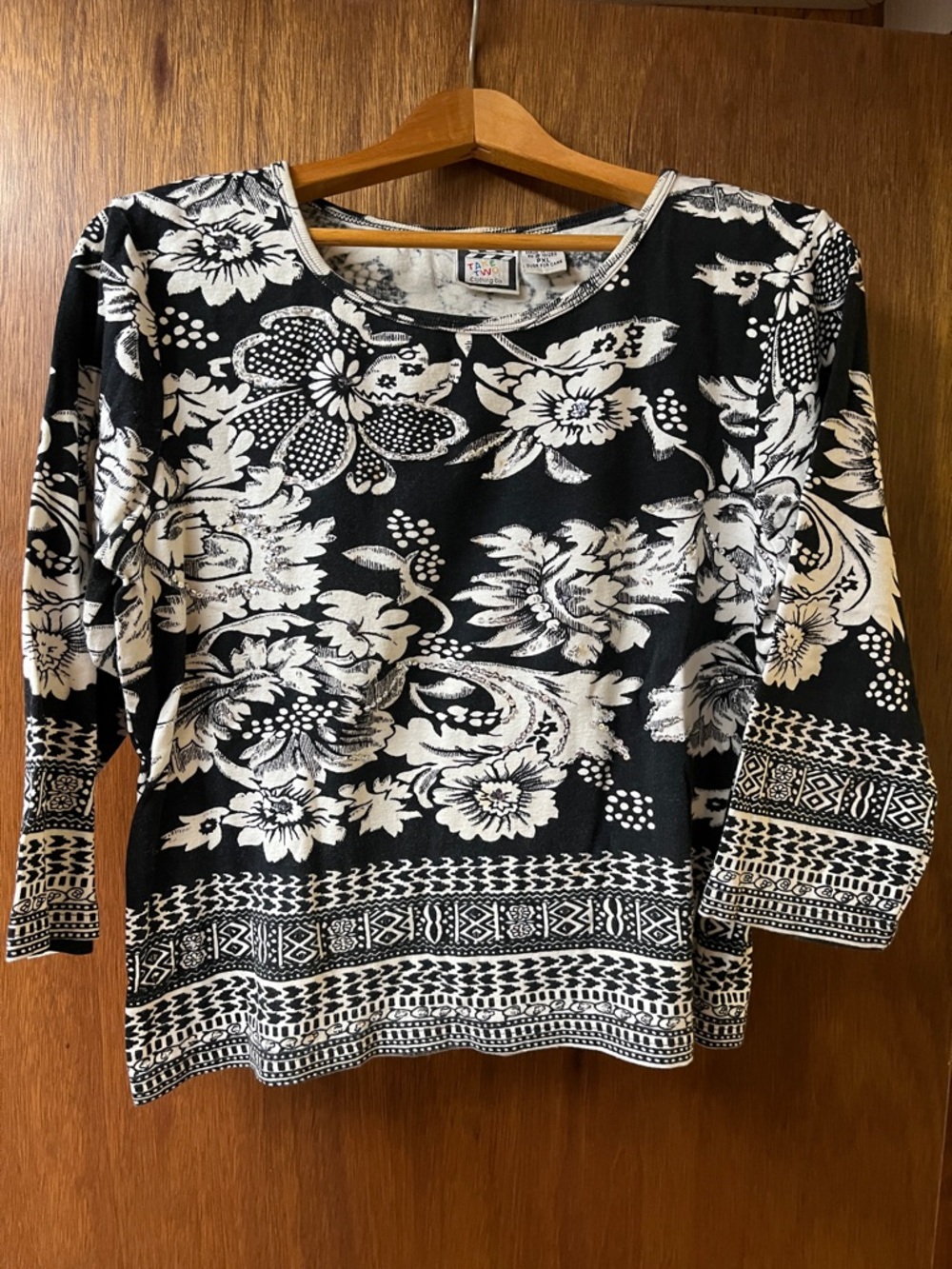 Women’s Black & White Floral Crewneck Top with sequin embellishments.